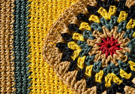 Raffia knitting texture close-up. Knitting from ECO material. Colorful raffia granny square. Hand knitted zigzag jewelry.