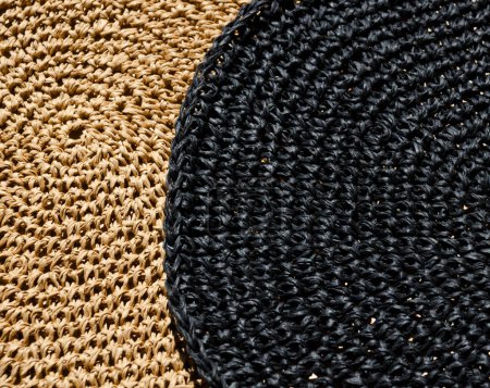 Raffia napkins, black and beige, close-up. Crochet. Eco material for handmade work.