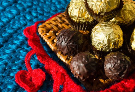 Photo for Chocolates and knitted hearts for Valentine's Day. Handmade from red yarn for the holiday. - Royalty Free Image