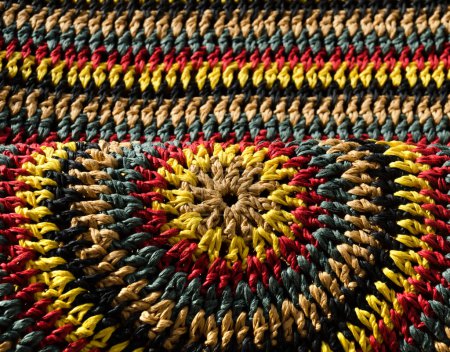 Beautiful pattern. Close-up of raffia crochet. Handmade knitted raffia jewelry.