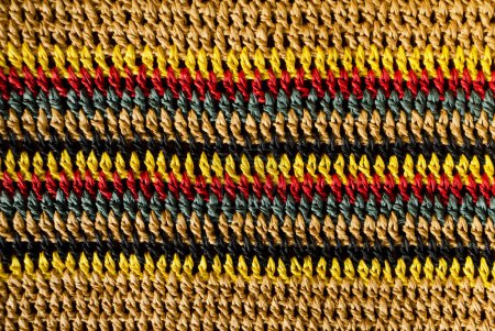Knitting pattern. Crochet close-up. Handmade knitted raffia jewelry