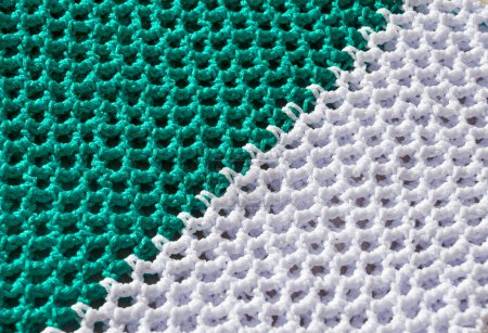 Texture of knitting polyester cord in green and white colors. Women's bags made of polyester cord. Durable and reliable cord for knitting bags and baskets.
