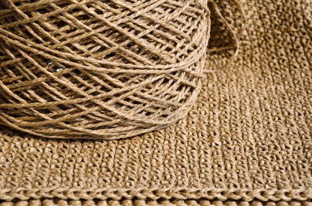 Raffia balls close-up on a burlap background. Raffia skeins are ready for knitting.