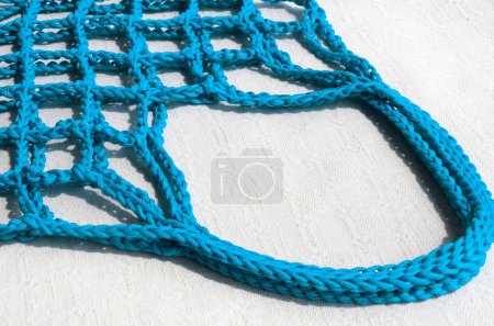 Women's bag made of polyester cord. Turquoise shopping bag for groceries. Durable mesh for food.