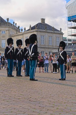 Photo for Unit of the Royal Life Guards standing at attention and relieve the departing guard at the post. Changing of the guard at Amalienborg Palace in Copenhagen Denmark 16-08-2023 - Royalty Free Image