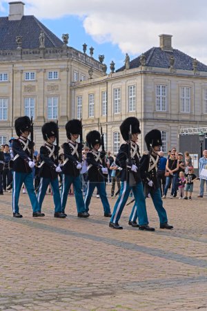 Photo for Unit of the Royal Life Guards marching in line and relieve the outgoing guard at the post. Changing of the Guard at Amalienborg palace in Copenhagen in Denmark. Copenhagen Denmark 16-08-2023 - Royalty Free Image