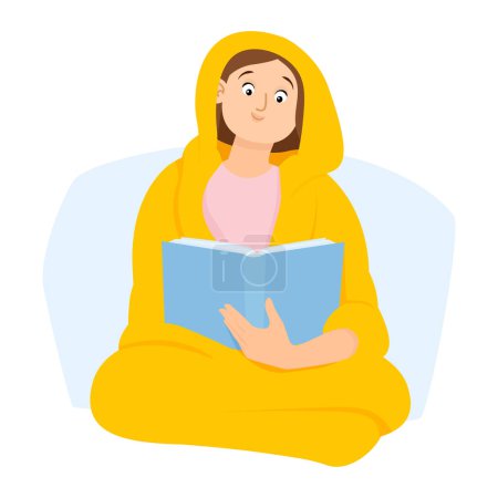 Junge Frau in eine Decke gehüllt liest ein Buch