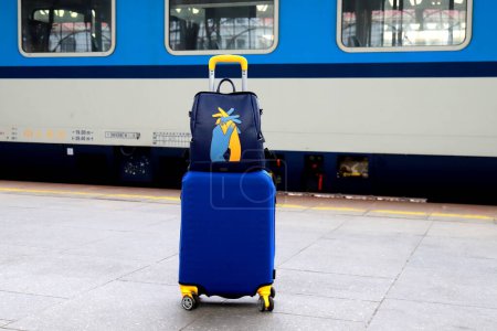 Suitcase and bag in colors of Ukraine flag at railway station, Prague, Czech Republic. Journey of Ukrainians, refugees, migrants. Travel, vacation, weekends, refugee, emigrant