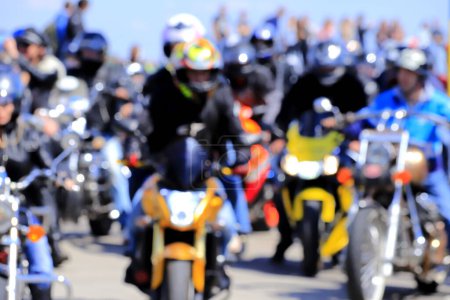 Motorcyclists on cool motorcycles, in helmets and leather jackets, ride along the road, Motorsport Dnepr, Ukraine, Blurred image