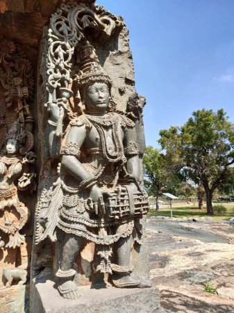 Stone idol outside Surya temple wall in Hoysaleswara temple at Halebidu, Karnataka, India