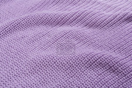 Photo for The texture of a lilac knitted fabric, close-up, fabric with folds, side view - Royalty Free Image