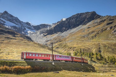 Swiss train in the alps mountains around Bernina pass, Engadine valley, Switzerland