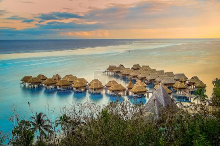 Photo for Bungalows over water at sunset, Moorea, French Polynesia, Tahiti - Royalty Free Image