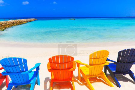Photo for Colorful wooden chairs on white sand beach in Aruba, Duth Caribbean at sunny day - Royalty Free Image