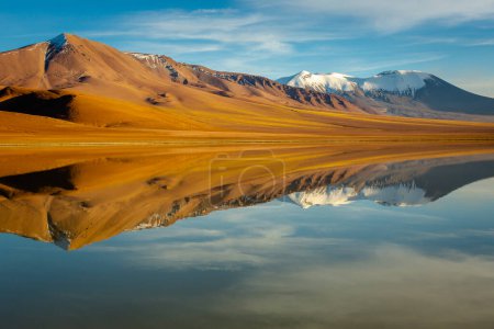 Salt lake Lejia reflection and idyllic volcanic landscape at Sunset, Atacama desert, Chile