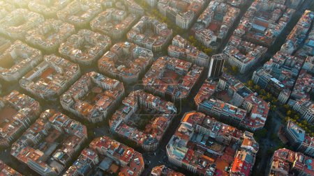 Barcelona city skyline, aerial view. Eixample residential district at sunset. Catalonia, Spain. Cityscape with typical urban octagon blocks