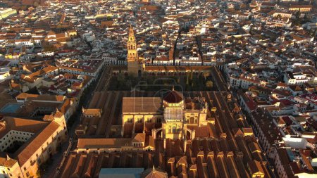 Photo for A view from above of the Mosque-Cathedral of Cordoba and the Roman bridge across the Guadalquivir River, both located in Andalusia, Spain - Royalty Free Image