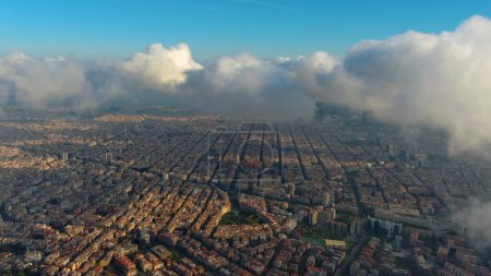Photo for Aerial Drone Helicopter Barcelona City above the clouds and fog, Basilica Sagrada Familia and Eixample residential famous urban grid. Catalonia, Spain - Royalty Free Image