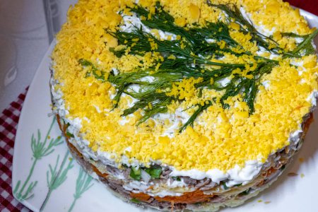 mimosa layered salad made of diced vegetables, canned fish, mayonnaise decorated with crumbled eggs, russian ukrainian cuisine, post soviet countries new year celebration festive salad