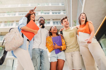 Photo for A group of multiracial teenage students smiling and having fun together in the university campus. Happy young people standing at the college with backpacks and notebooks. Friendship concept. High - Royalty Free Image