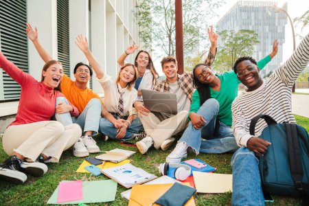 Photo for Portrait of a big group of happy teenage students sitting at university campus lawn, gesturing and celebrating together a academic goal. Positive multiracial teenagers gesturing and looking at camera - Royalty Free Image
