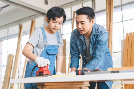 Photo for Southeast asian family father and son diy or repair at home concept. Dad teach using tools about carpenter or engineer education skill with child at workshop. - Royalty Free Image