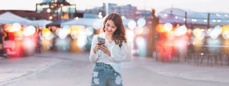 Photo for People using internet technology for communication lifestyles. Beauty young adult asian woman using smart phone and texting social message for dating online. Banner background. - Royalty Free Image