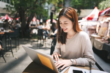 Photo for Happy young adult asian woman business work with laptop computer at outdoor cafe restaurant area on weekend. Single people city lifestyle on day concept. - Royalty Free Image