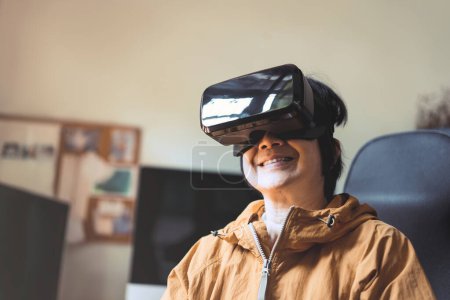 Photo for New normal lifestyle at home with modern technology concept. Elder woman people wear virtual reality headset for life experience. Older relax healthy hobby on day play vr game. - Royalty Free Image