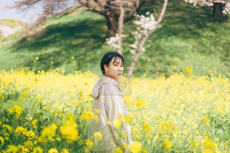 Photo for Portrait beautiful japanese woman with short hair. Sakura tree and flower background. Relax in nature with spring season. - Royalty Free Image