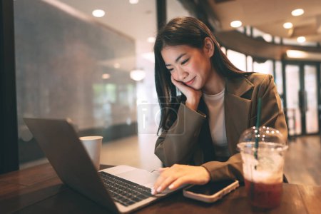 Photo for Business freelance young adult asian woman using laptop computer for work at coffee cafe. Urban people lifestyle with modern technology on day. Digital nomad. Happy smile face. - Royalty Free Image