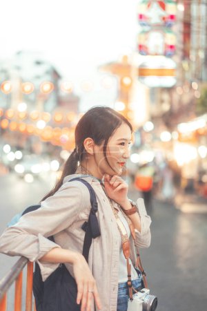 Photo for Walking young adult asian woman traveller backpack. People traveling in city lifestyle chinatown street food market Bangkok, Thailand. Staycation summer trip concept. Bokeh on background. - Royalty Free Image