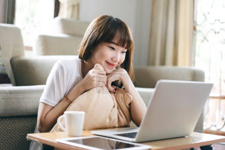 Photo for Asia student study online stay at home for new normal concept. Asian teenager woman meeting via internet video conference with laptop. Living room background with window light. - Royalty Free Image