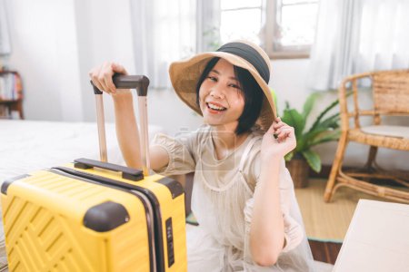 Photo for People moving house to new home or apartment concept. Happy smile woman begin relocation in cozy style room with window. Girl with short hair and casual clothing using travel luggage. - Royalty Free Image