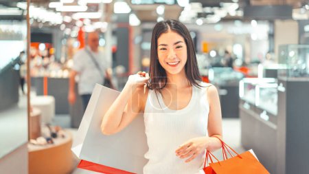 Photo for People city lifestyles with buying consumerism. Portrait young beautiful face asian woman shopping bags. Happy smile face standing at indoors department store. - Royalty Free Image