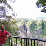 Barron Falls viewing platform with German blonde man in colorful shorts and pink t-shirt Australia. High quality photo