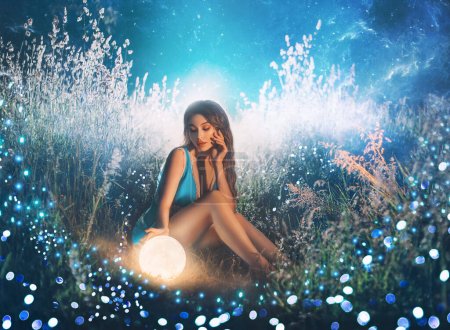 Photo for Art photo Fantasy woman touching moon with hand, glowing ball planet. night nature dark forest. Mystic moon light magic universe outer space. Fairy flying bright sparkle stars white fog blue grass. - Royalty Free Image
