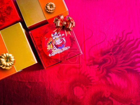 Photo for The auspicious Red gift box for Chinese New Year celebrations displayed with the red dragon copy space for banner. Abstract and background concept. - Royalty Free Image