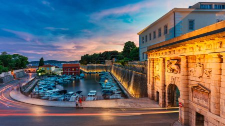 Photo for The Land Gate in Zadar at sunset, the main entrance into the city, built by a Venetian architect Michele Sanmicheli in 1543, Zadar, Croatia. The Land Gate to the Old City of Zadar, Croatia. - Royalty Free Image