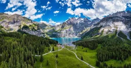 Photo for Famous Oeschinensee with Bluemlisalp mountain on a sunny summer day. Panorama of the azure lake Oeschinensee. Swiss alps, Kandersteg. Amazing tourquise Oeschinnensee with waterfalls, Switzerland. - Royalty Free Image
