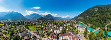 Photo for Aerial view over the city of Interlaken in Switzerland. Beautiful view of Interlaken town, Eiger, Monch and Jungfrau mountains and of Lake Thun and Brienz. Interlaken, Bernese Oberland, Switzerland. - Royalty Free Image