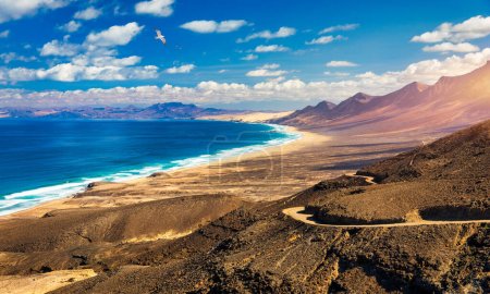 Photo for Amazing Cofete beach with endless horizon. Volcanic hills in the background and Atlantic Ocean. Cofete beach, Fuerteventura, Canary Islands, Spain. Playa de Cofete, Fuerteventura, Canary Islands. - Royalty Free Image