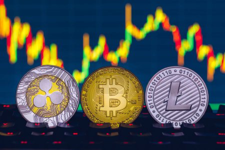 Photo for Bitcoin, litecoin and ripple coins currency finance money on graph chart background. Bitcoin as most important cryptocurrency concept. Stack of cryptocurrencies with a golden bitcoin in the middle. - Royalty Free Image
