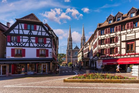 Photo for Obernai, France - 2 July 2022: Main square in Obernai, Alsace, France. Church of St. Peter and St. Paul in the center of Obernai, Bas-Rhin, Alsace, France - Royalty Free Image