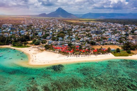 Beautiful Mauritius Island with gorgeous beach Flic en Flac, aerial view from drone. Mauritius, Black River, Flic-en-Flac view of oceanside village beach and luxurious hotel in summer.