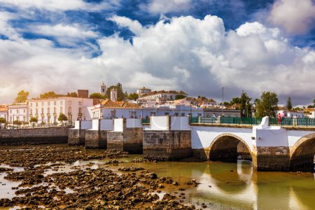 View of the city of Tavira, charming architecture of Tavira, Algarve, Portugal. Santiago of Tavira church in the old town of the beautiful city of Tavira in a sunny day. Algarve region, Portugal