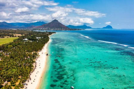 Beach of Flic en Flac with beautiful peaks in the background, Mauritius. Beautiful Mauritius Island with gorgeous beach Flic en Flac, aerial view from drone. Flic en Flac Beach, Mauritius Island.