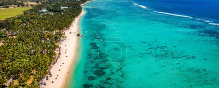 Beautiful Mauritius island with beach Flic en flac. Coral reef around tropical palm beach, Flic en Flac, Mauritius. Aerial view of a beautiful beach along the coast in Flic en Flac, Mauritius.