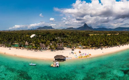 Beautiful Mauritius Island with gorgeous beach Flic en Flac, aerial view from drone. Mauritius, Black River, Flic-en-Flac view of oceanside village beach and luxurious hotel in summer.