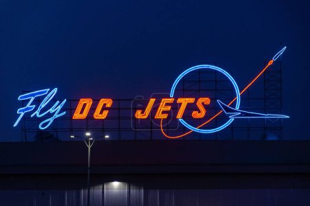 Photo for An illuminated old Fly DC Jets sign on a McDonald's restaurant roof in Long Beach - Royalty Free Image